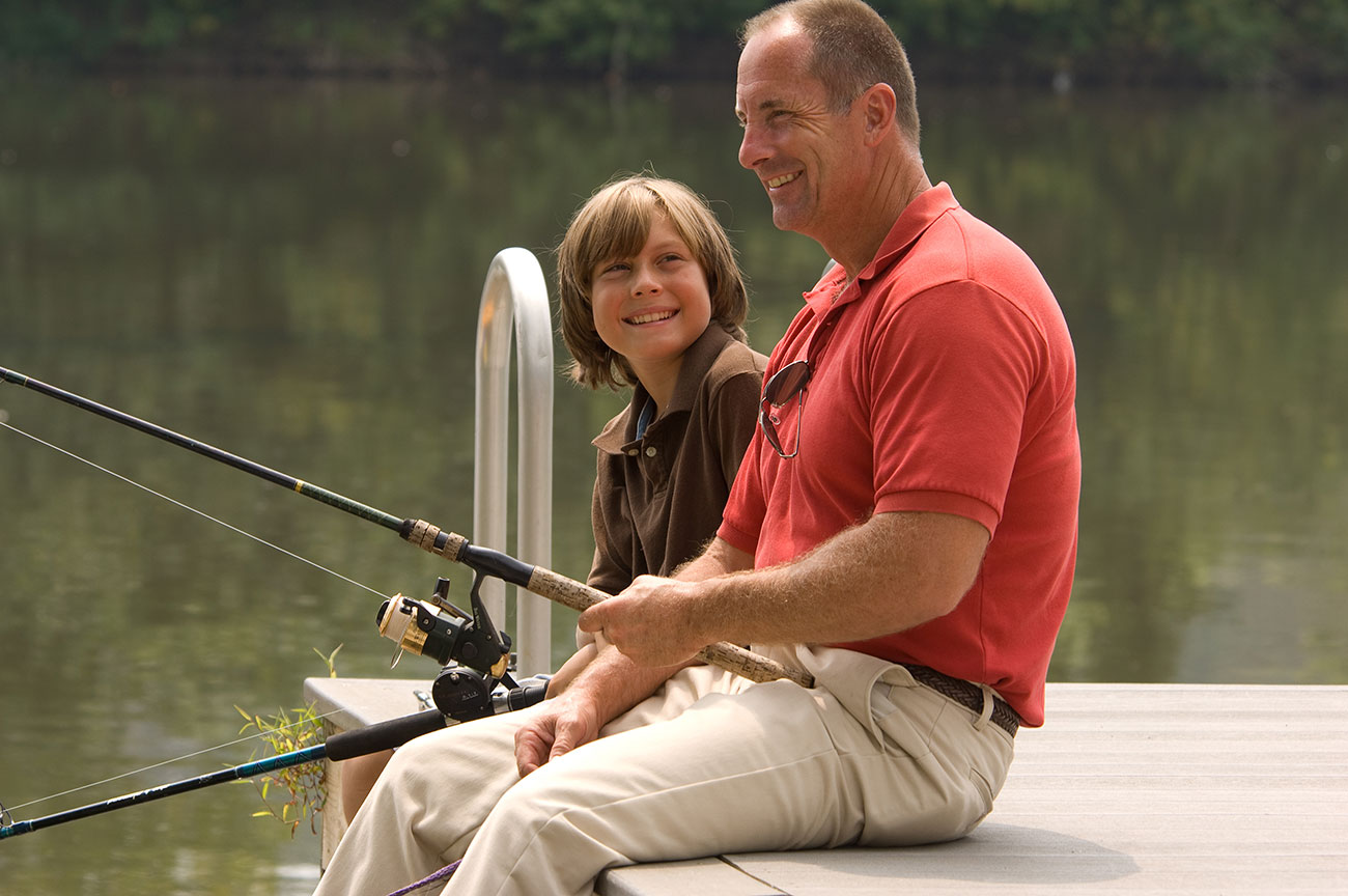 father-and-son-fishing-off-dock-on-vacation