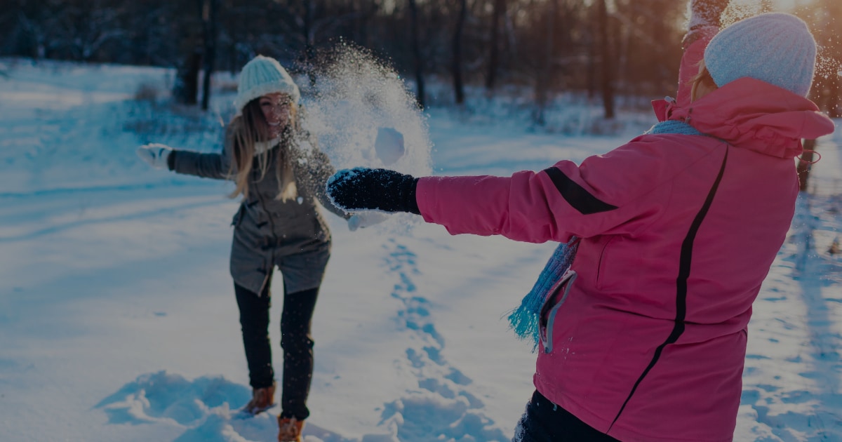 Winter activities in Sylvan Lake - two women playing in the snow featured image